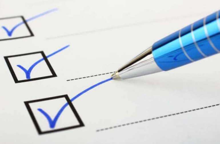 Pen checking boxes on checklist